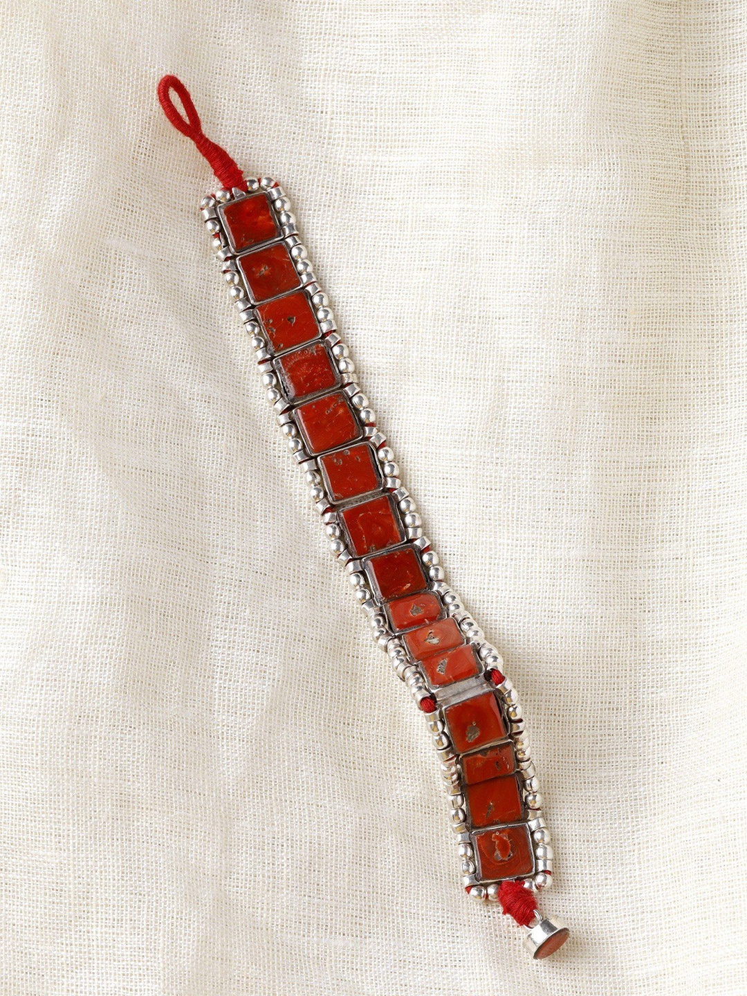

Exotic India Square Cut Coral Stone Sterling Silver Bracelet