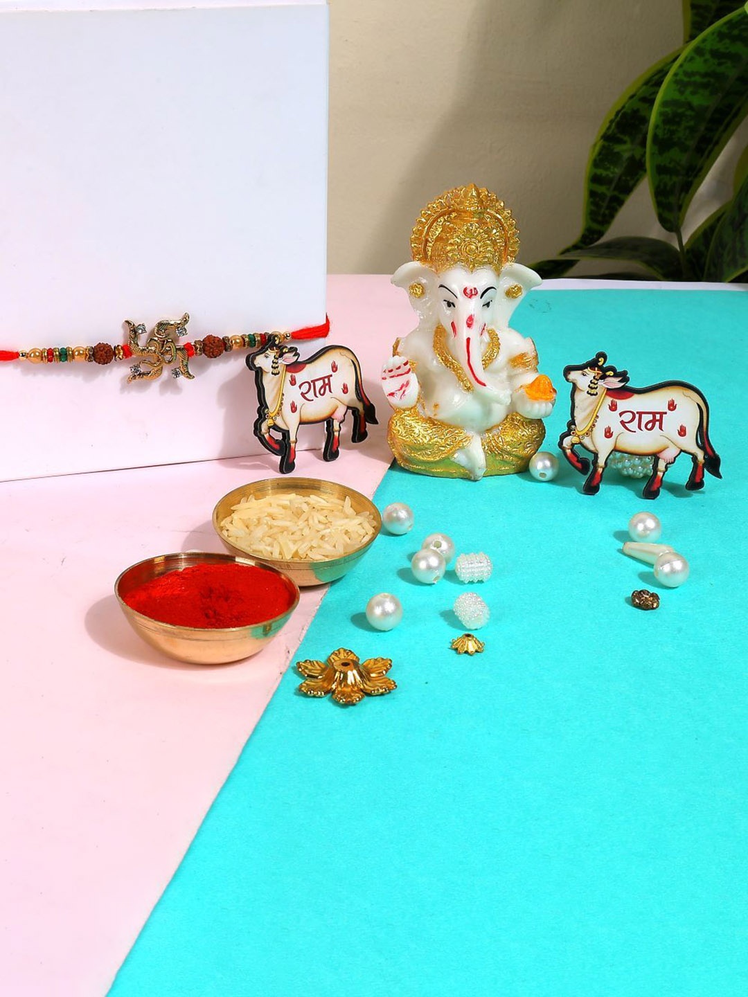 

Phirki Studio Set of 2 Stone Studded Rakhi With God Figure Table stand & Roli Chawal, Red