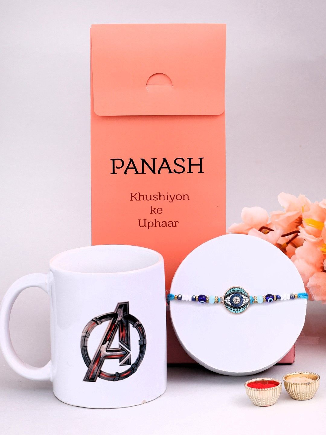 

PANASH Evil Eye Stone Studded & Beaded Rakhi With Roli Rice & Mugs, Blue