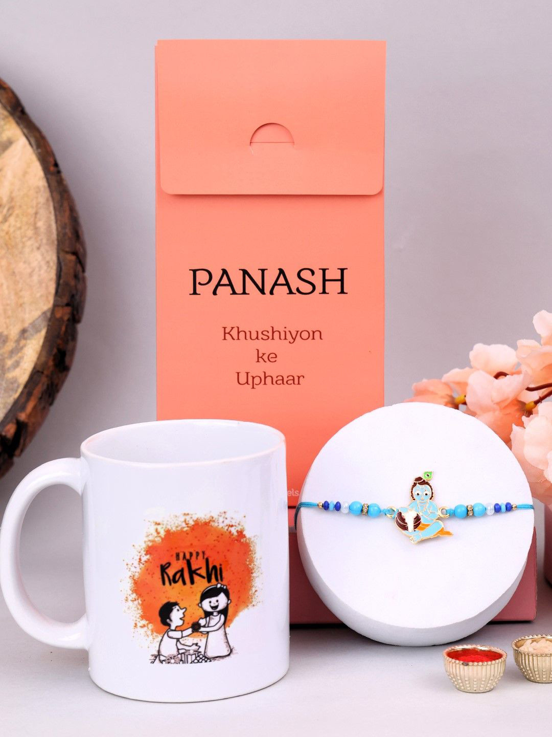 

PANASH Set Of 2 Beaded Rakhi With Printed Mug And Roli Chawal, Gold