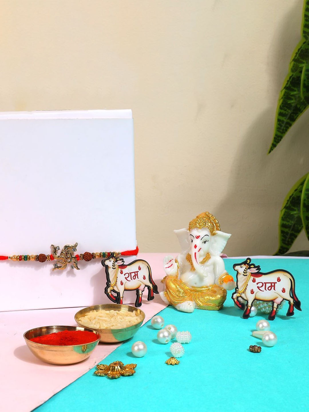 

Phirki Studio Set of 2 Stone Studded Rakhi With God Figure Table stand & Roli Chawal, Red