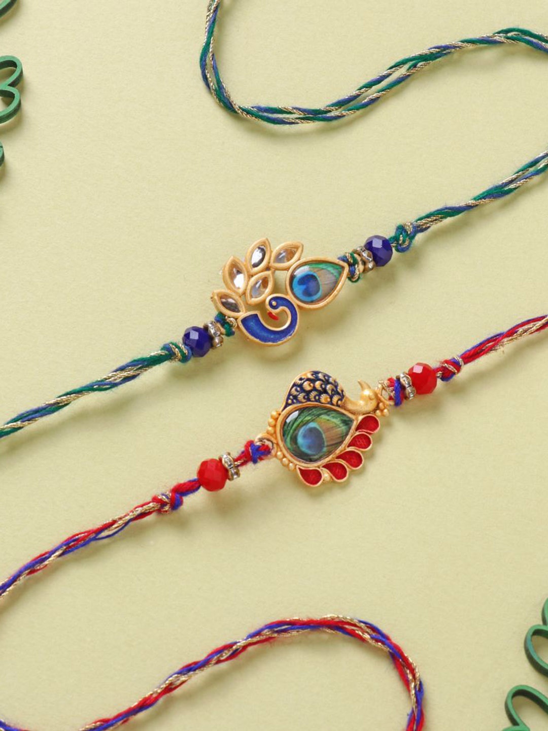 

Floweraura Set Of 2 Stone Studded & Beaded Thread Rakhis With Roli Chawal, Red