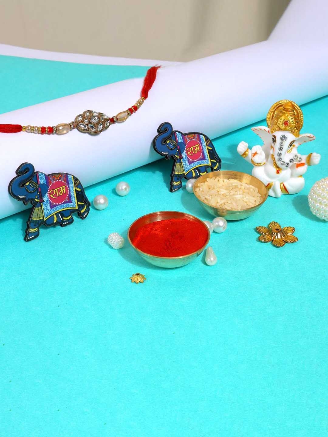 

Phirki Studio Set of 2 Stone Studded Rakhi With God Figure Table stand & Roli Chawal, Gold