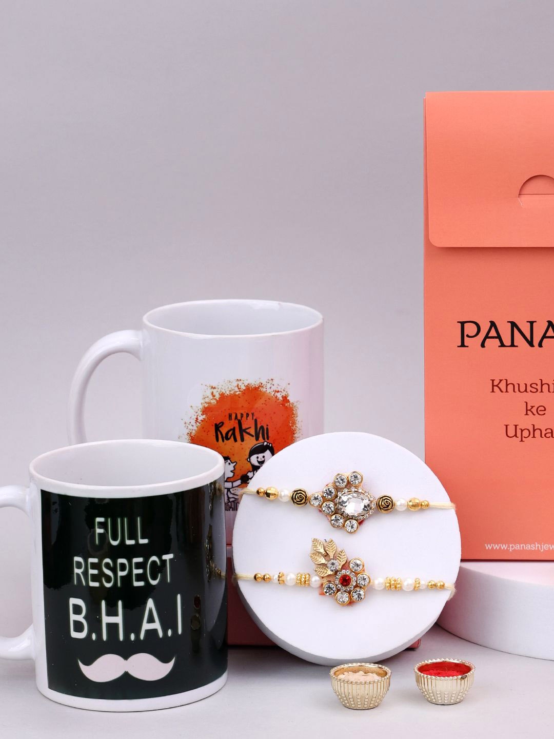 

PANASH Set Of 4 Stone-Studded & Beaded Rakhi With Mugs & Roli Chawal, Gold