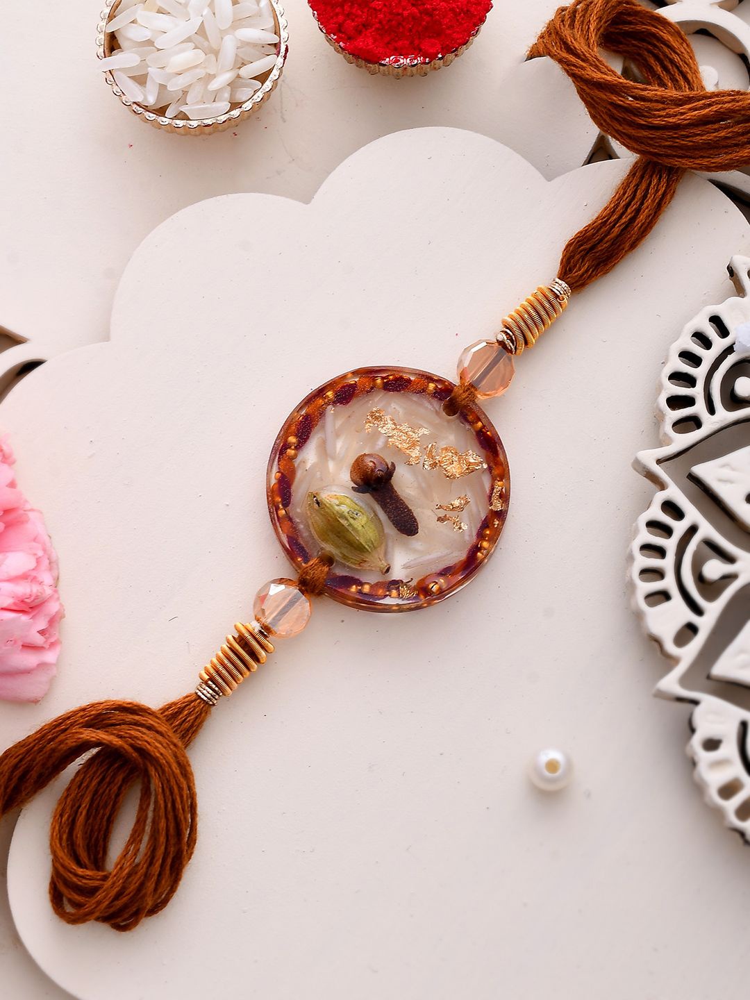 

Anouk Laung & Elaichi Resin Thread Rakhi With Roli Chawal & Greetings Card, Brown