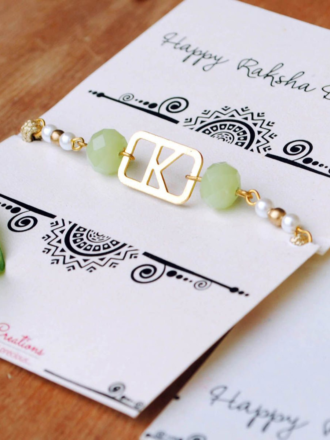 

BeAbhika N Initial Beaded Rakhi With Roli & Chawal Capsules, Gold