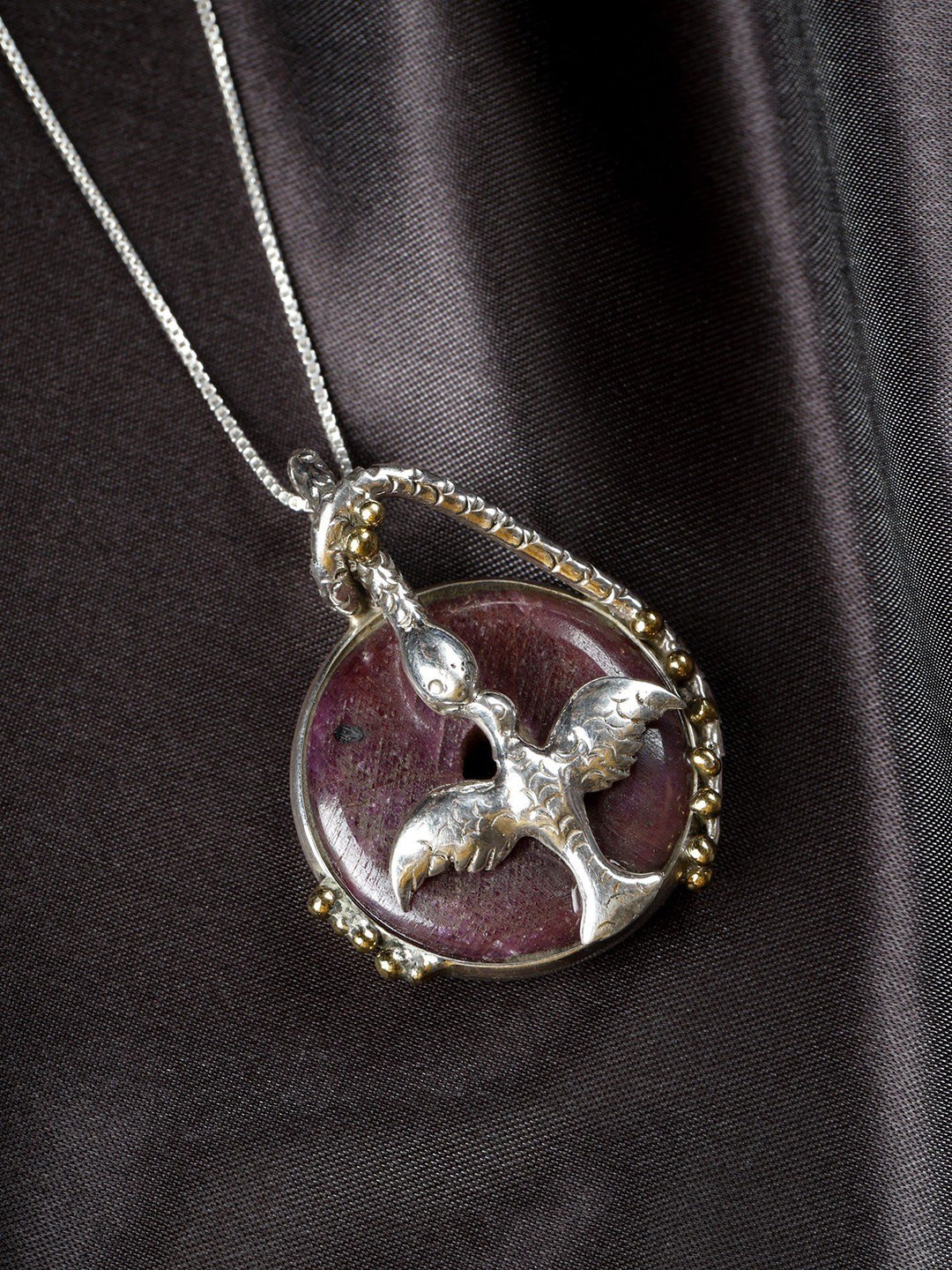 

Exotic India Round Raw Ruby Sterling Silver Bird Pendant