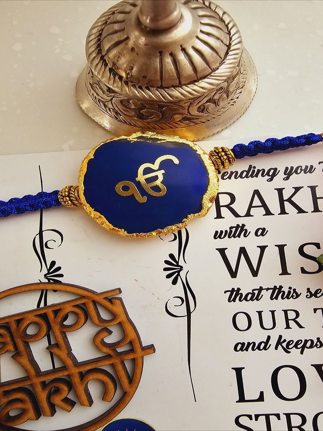 

HOMEARTE Agate Stone Designer Thread Rakhi With Greeting Card & Roli Chawal, Blue