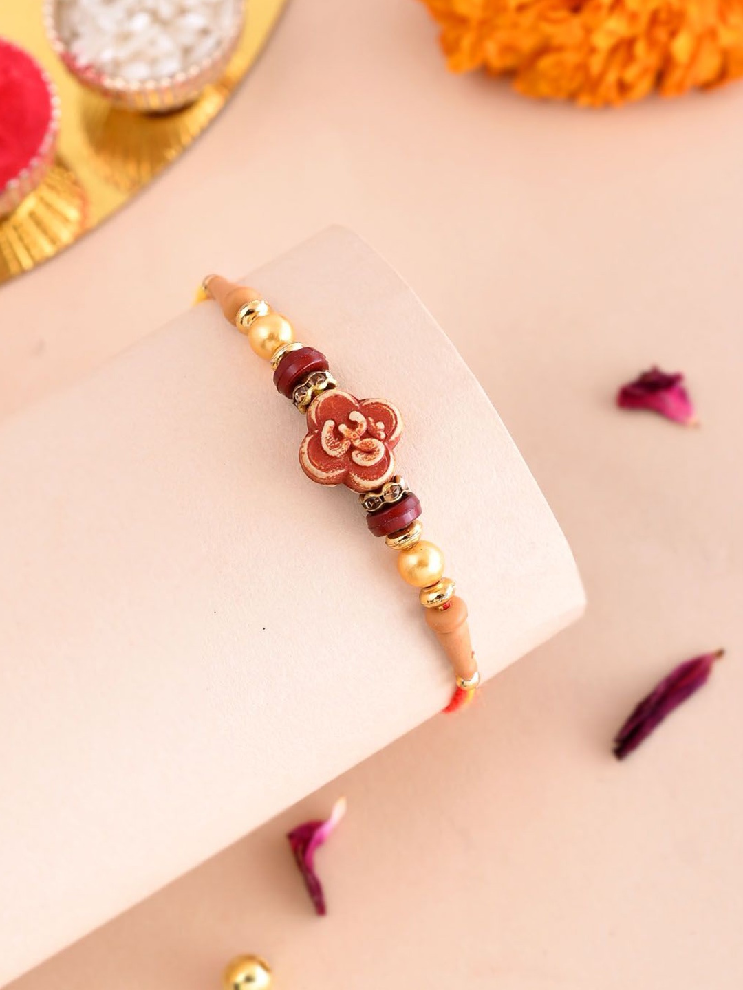 

Anouk Red Stone Studded & Beaded Om with Rudraksh Charm Thread Rakhi With Roli Chawal, Gold