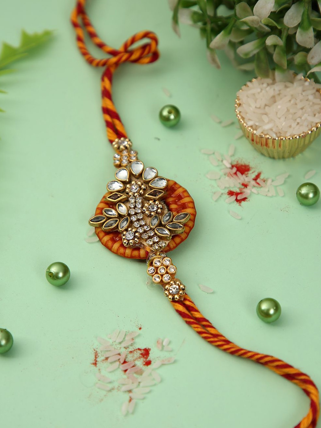 

Anouk Kundan Studded Floral Thread Rakhi With Roli Chawal & Greetings Card, Gold