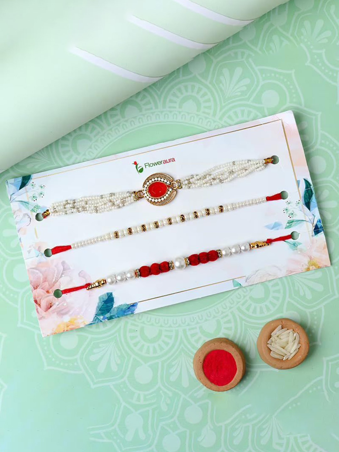 

Floweraura Set Of 3 Stone Studded & Beaded Designer Rakhi With Roli Chawal, Red