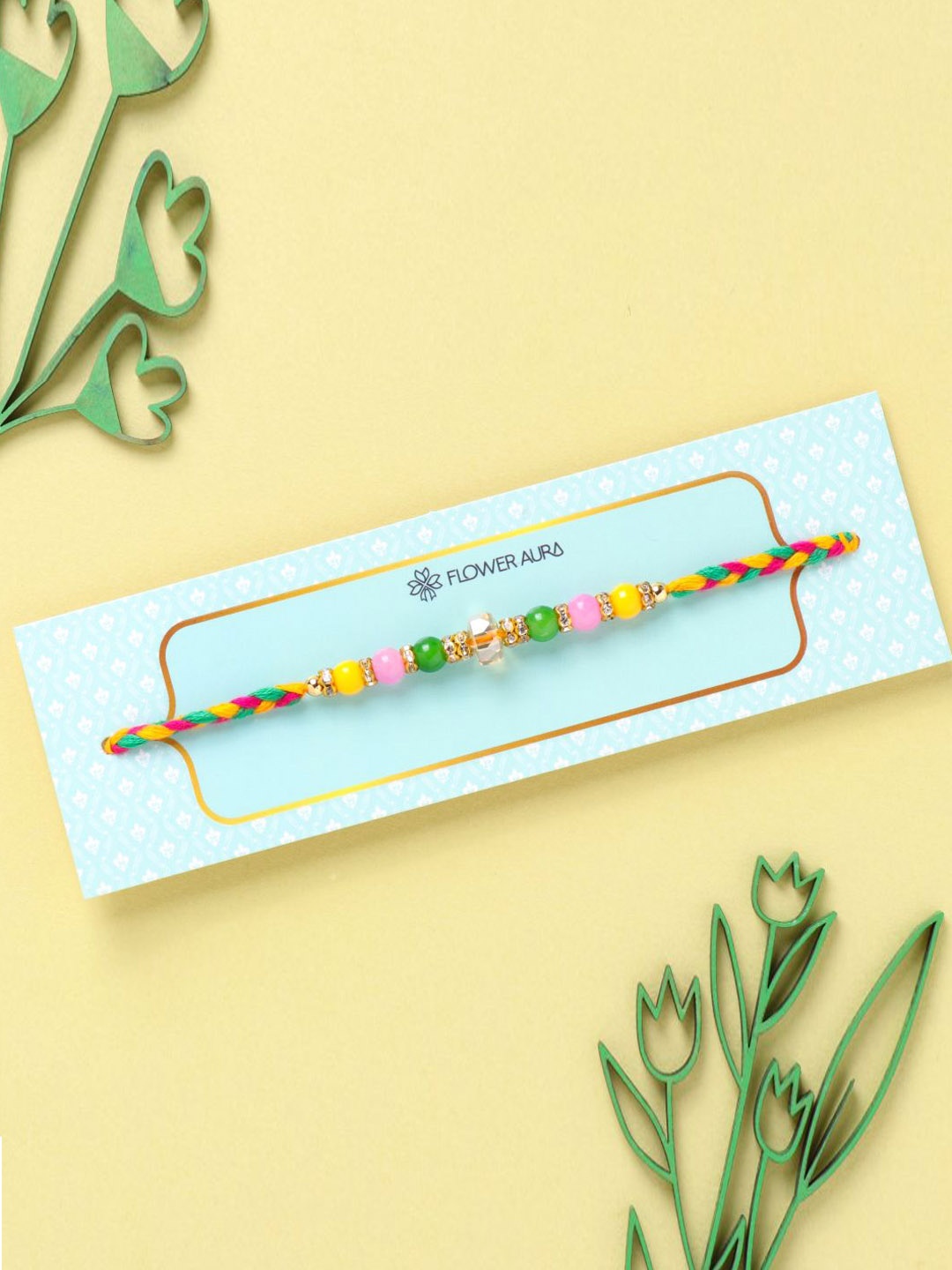 

Floweraura Stone Studded & Pearl Beaded Thread Rakhi With Roli Chawal, Green