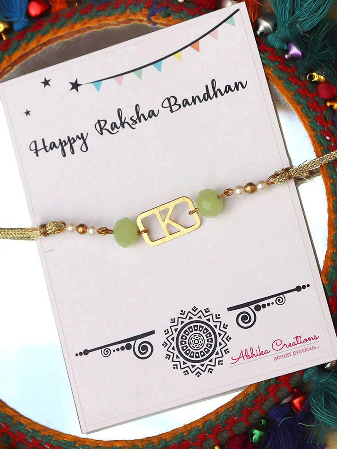 

BeAbhika W Initial Beaded Thread Rakhi with Roli Chawal Capsules, Green