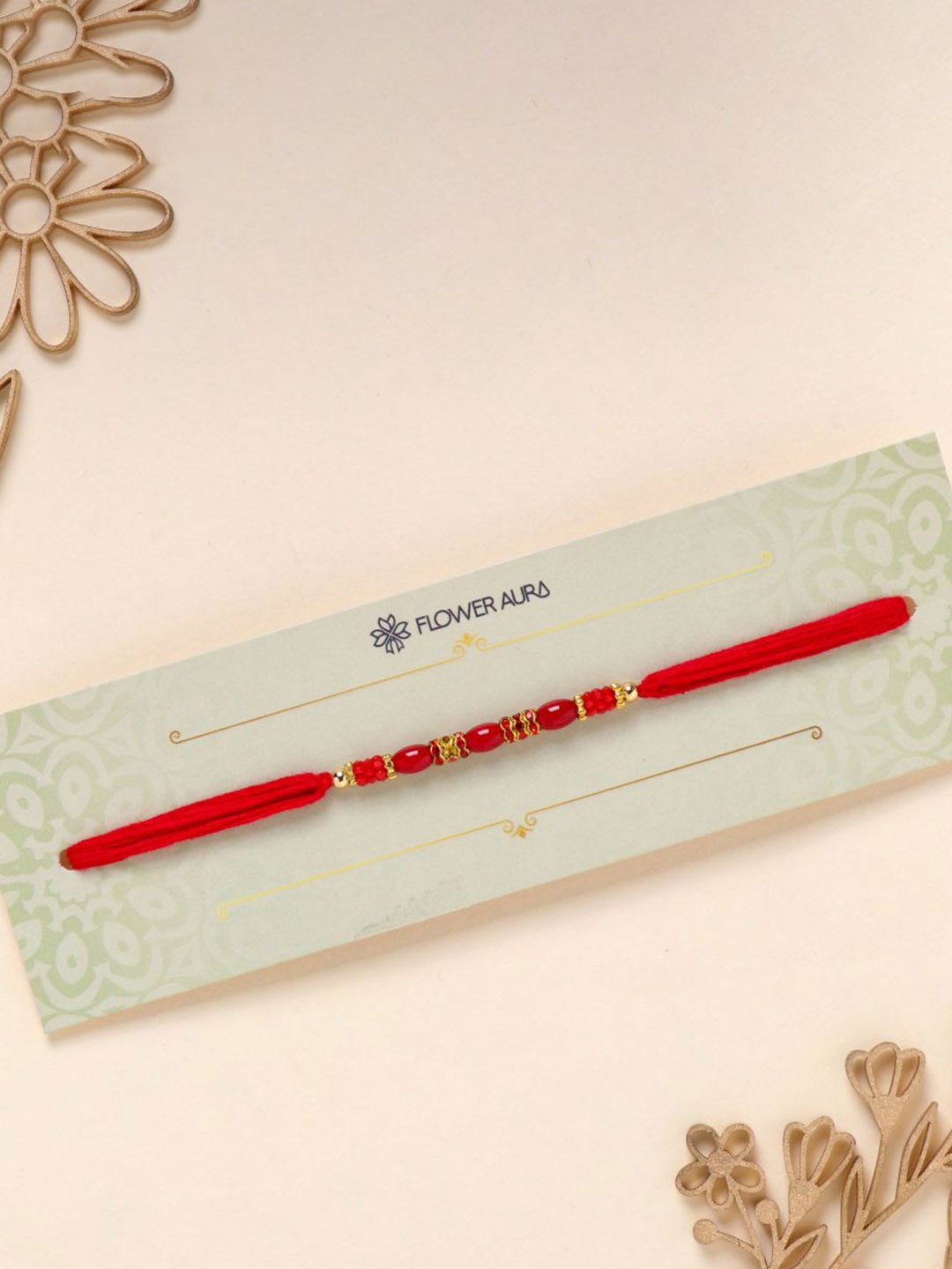 

Floweraura Stone Studded & Beaded Thread Rakhi With Roli Chawal, Red