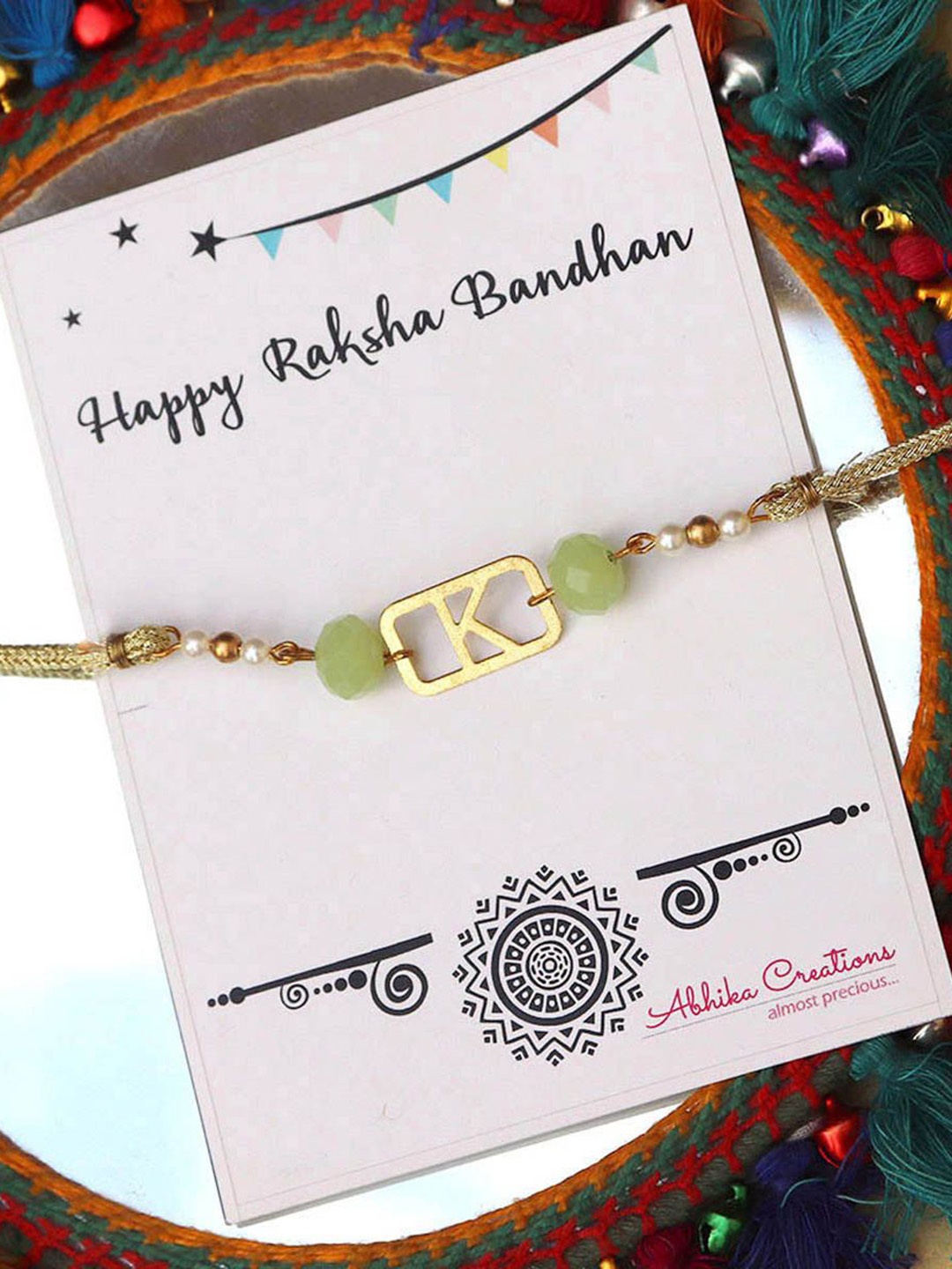 

BeAbhika P Initial Beaded Thread Rakhi with Roli Chawal Capsules, Green