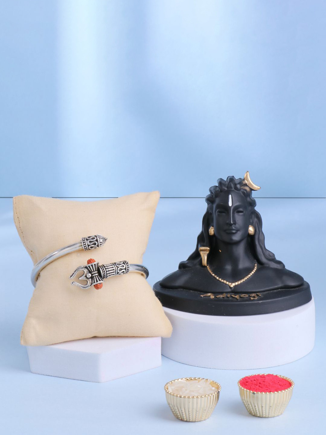 

Floweraura Set of 2 Silver Om Bracelet Rakhi With Lord Shiva Adiyogi Idol & Roli Chawal