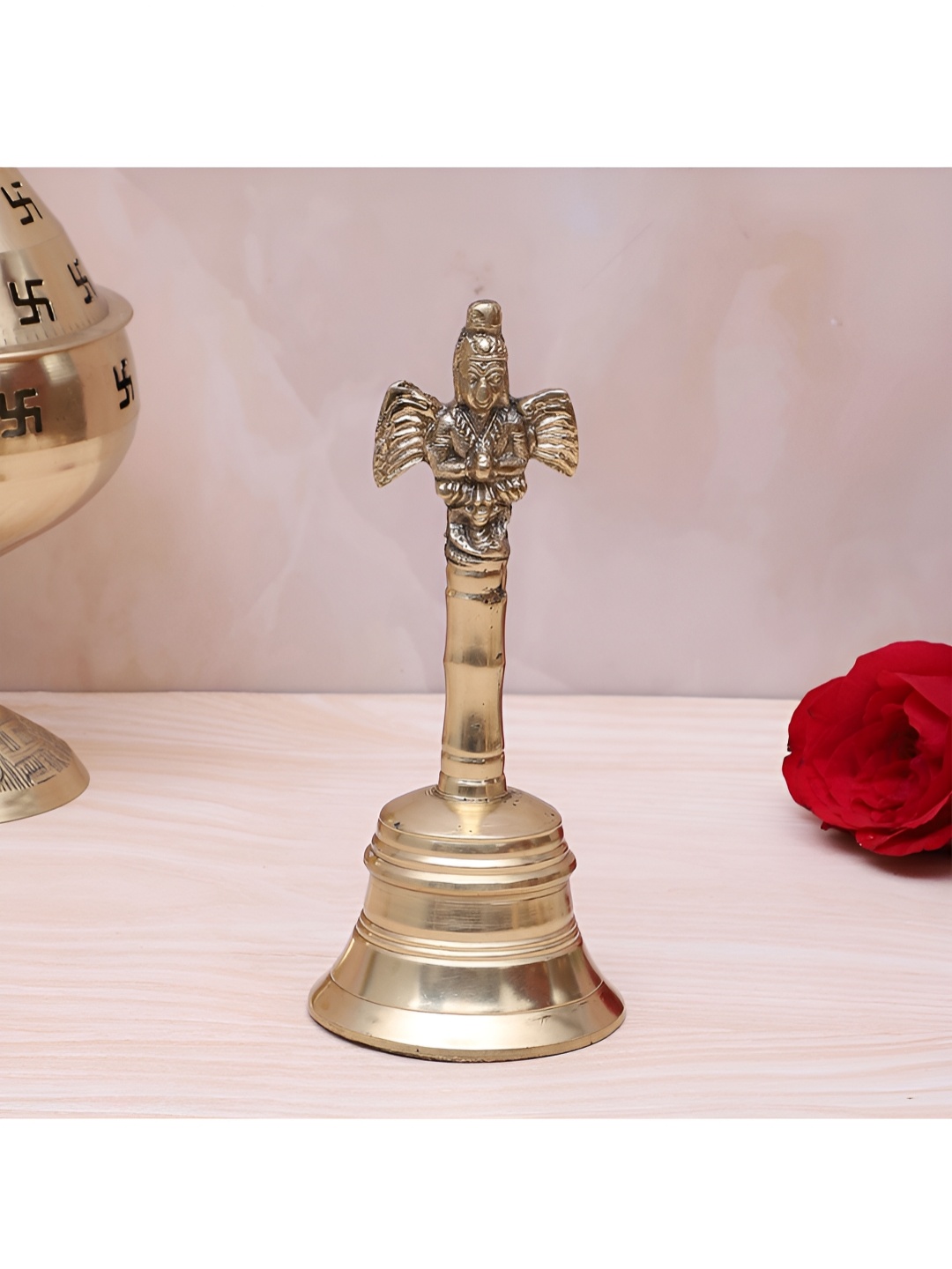 

Two Moustaches Gold Toned Garuda Design Brass Pooja Hand Bell