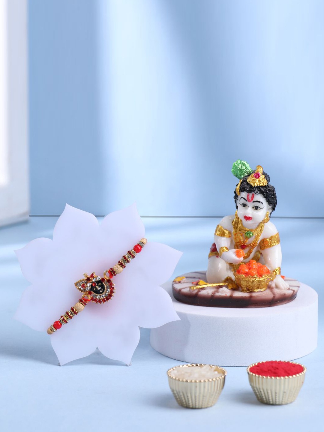 

Floweraura Set of 2 Beaded Rakhi With Lord Bal Gopal Krishna Idol & Roli Chawal, Red