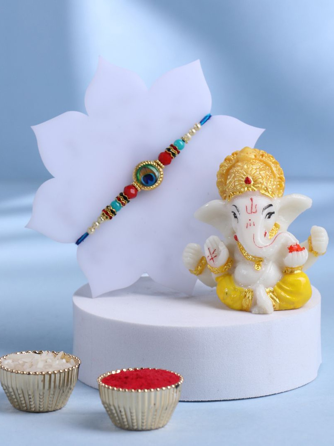 

Floweraura Set of 2 Beaded Rakhi With Lord Ganesha Idol & Roli Chawal, Blue
