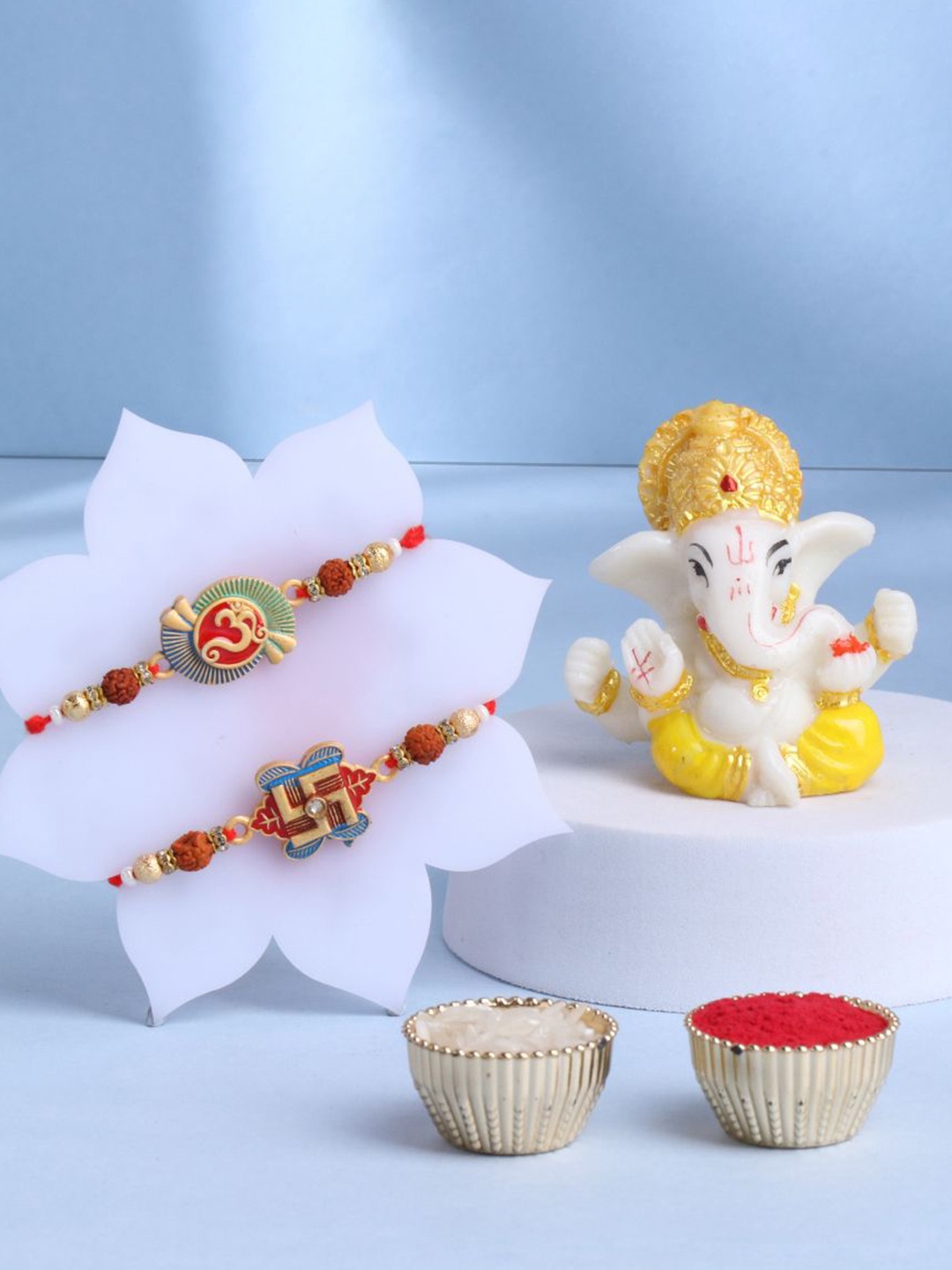 

Floweraura Set Of 3 Rakhis With Lord Ganesha Idol & Roli Chawal Gift Set, Red