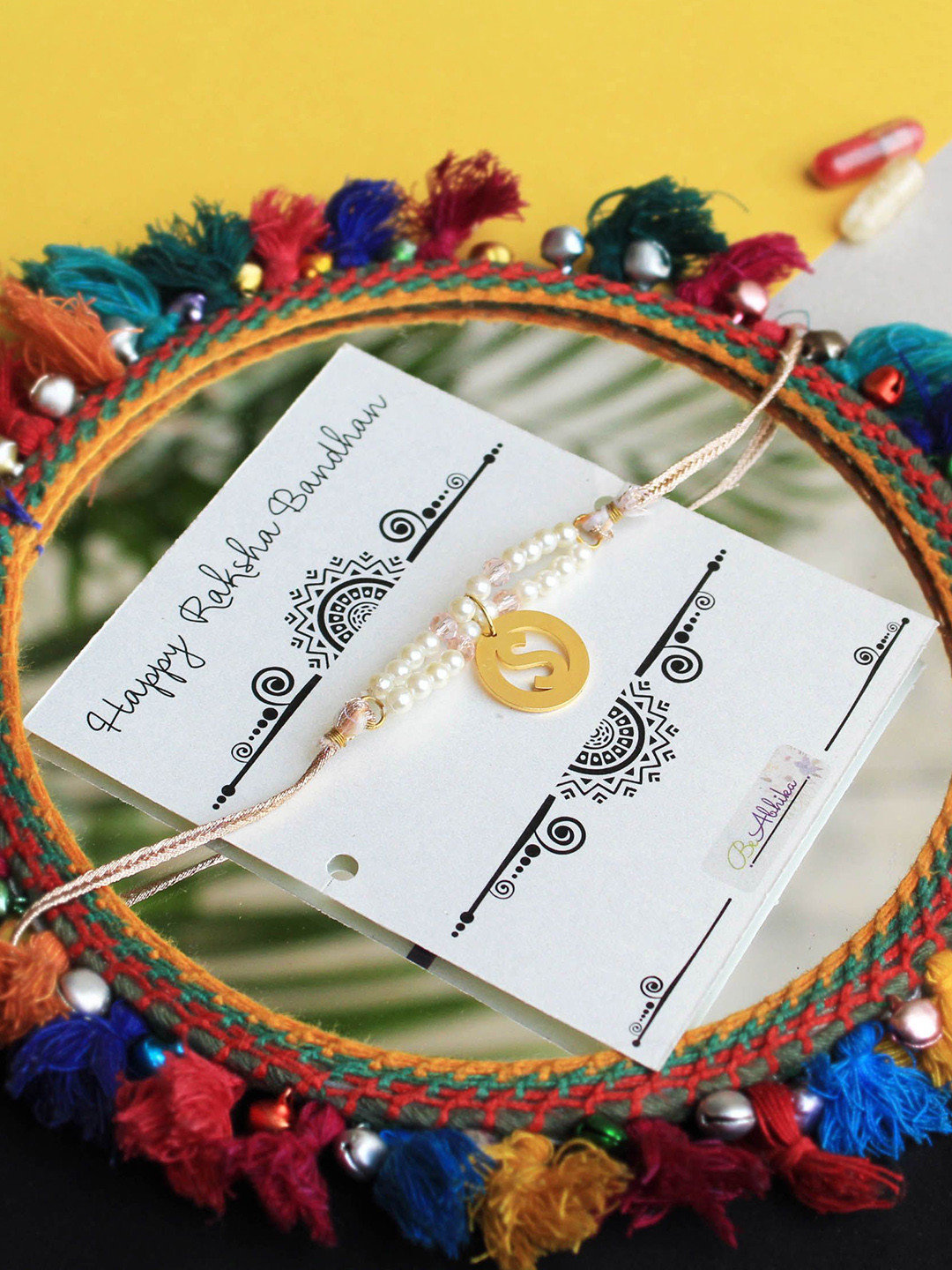 

BeAbhika "E" Initial Beaded Thread Rakhi With Roli & Chawal Capsules, Gold