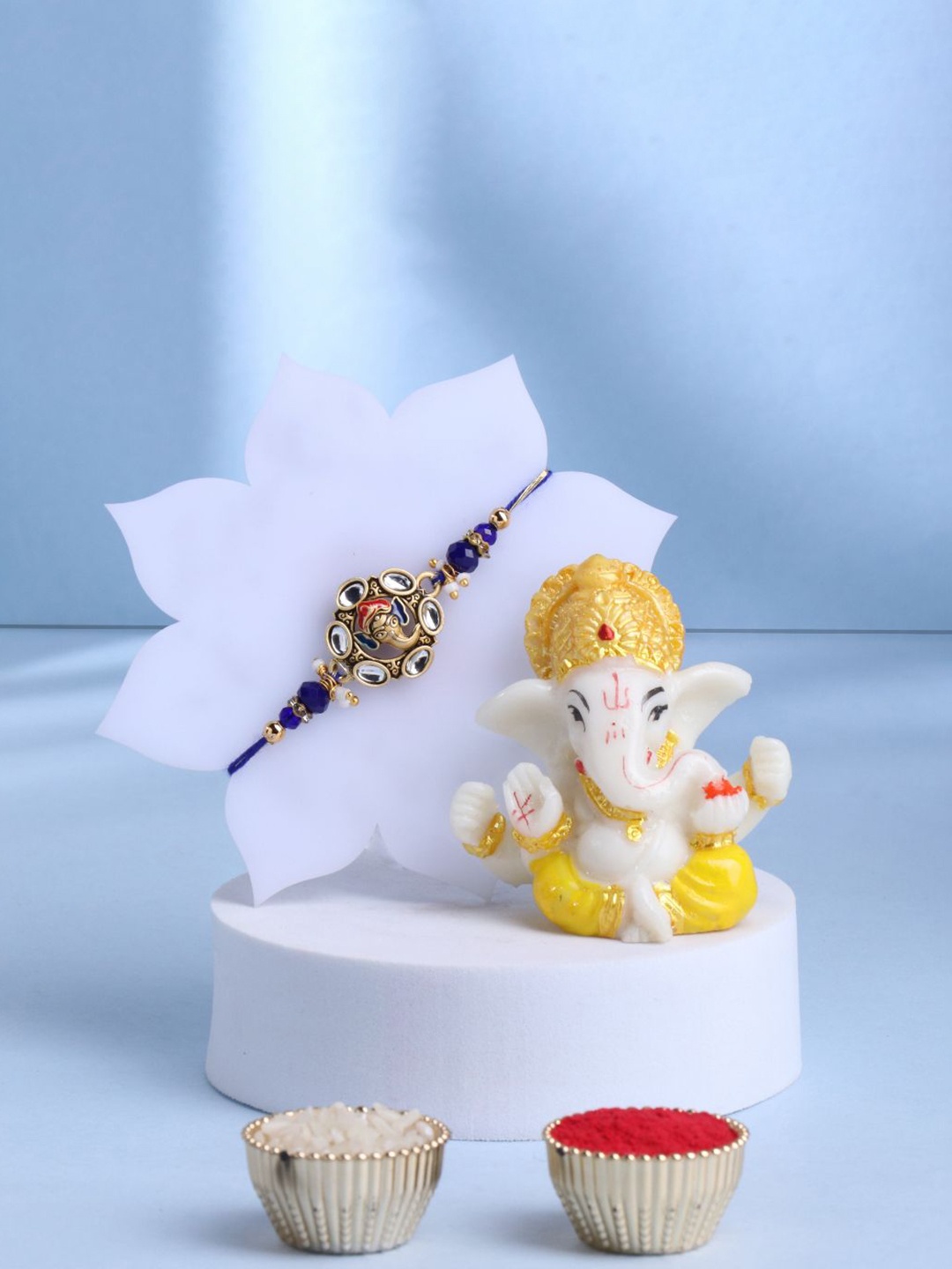 

Floweraura Beaded Rakhi With Lord Ganesha Idol Showpiece Gift Set, Gold