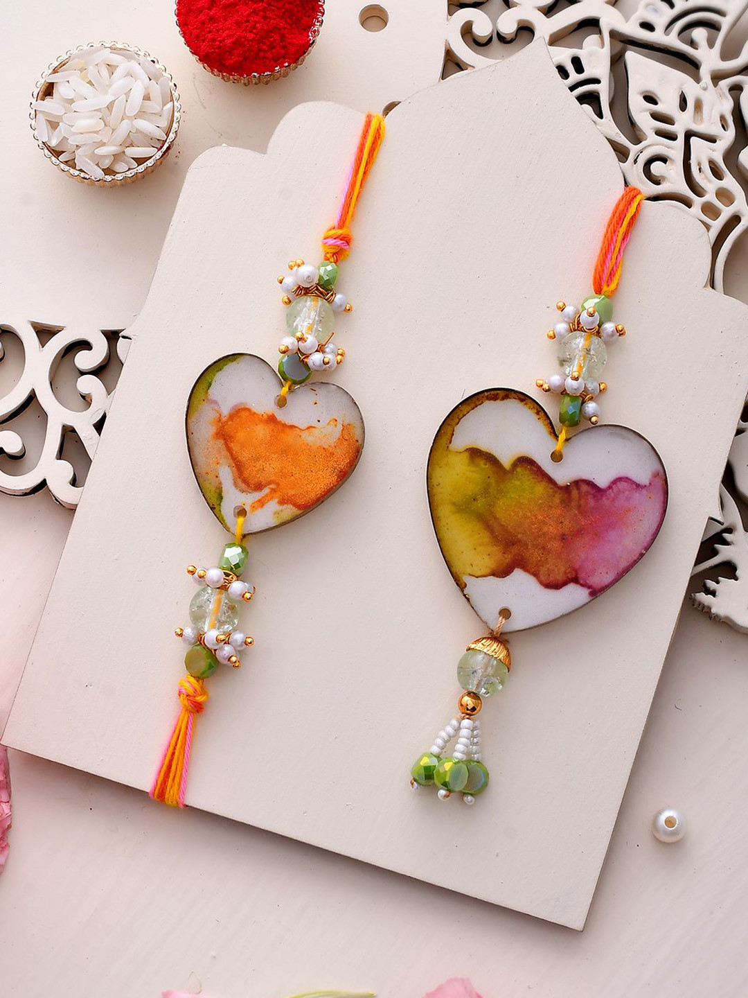 

Sangria Orange Heart Shaped Resin Work Bhaiya Bhabhi Rakhi With Roli Chawal & Card
