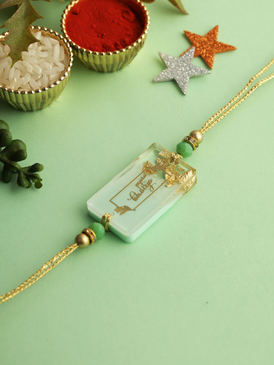 

Sangria Beaded Thread Rakhi with Roli Chawal & Greetings Card, Green