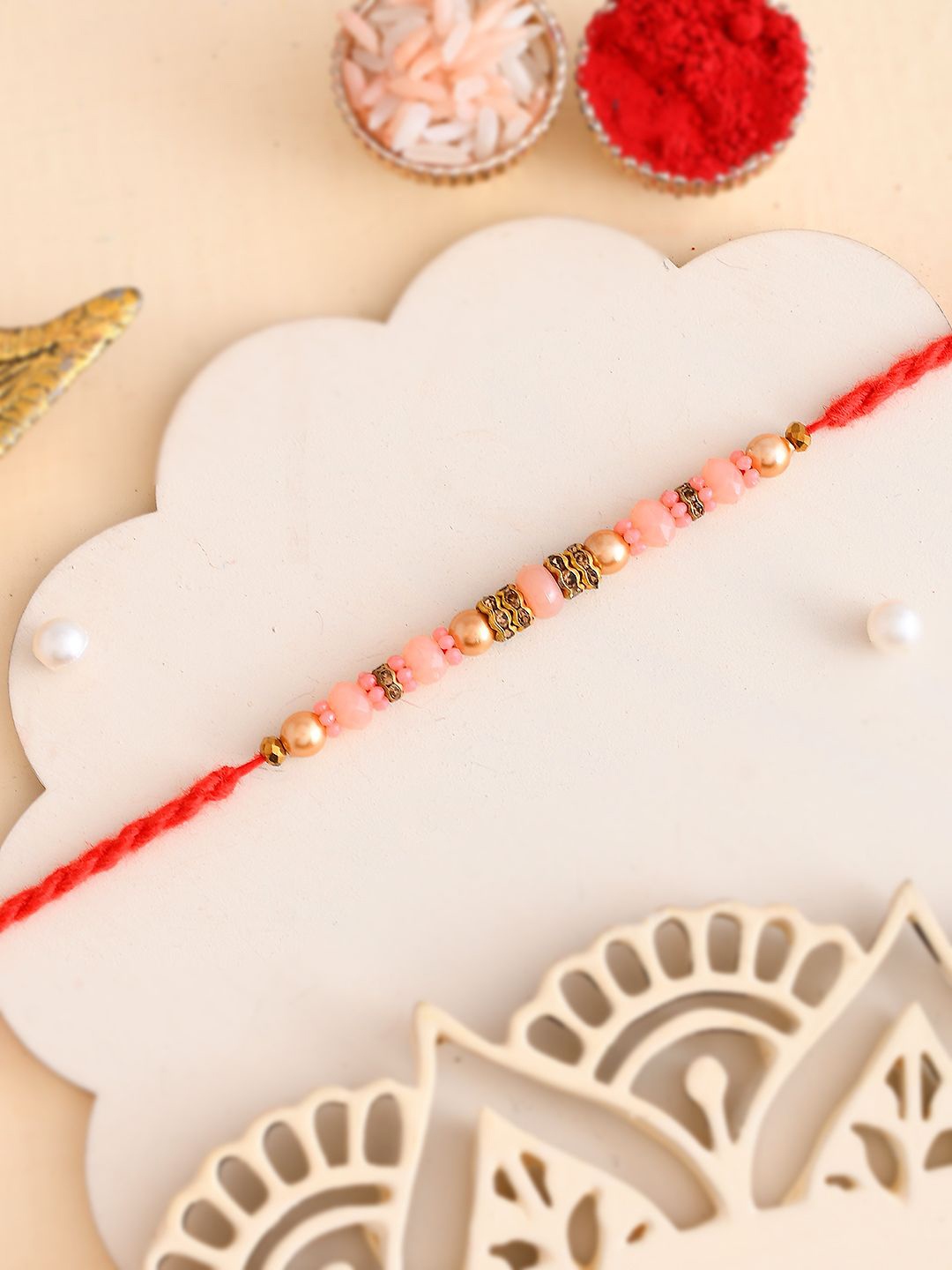 

Aapno Rajasthan Beaded Twisted Rakhi With Roli Chawal & Greeting Card, Gold