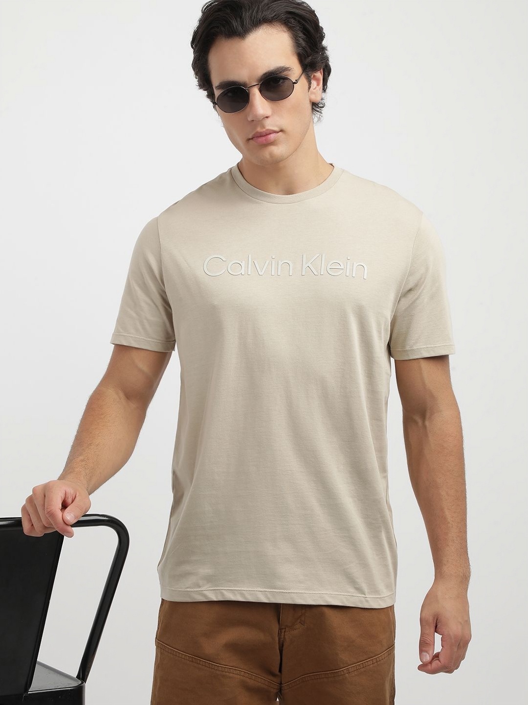 

Calvin Klein Jeans Men Solid Round Neck Cotton T-shirt, Beige