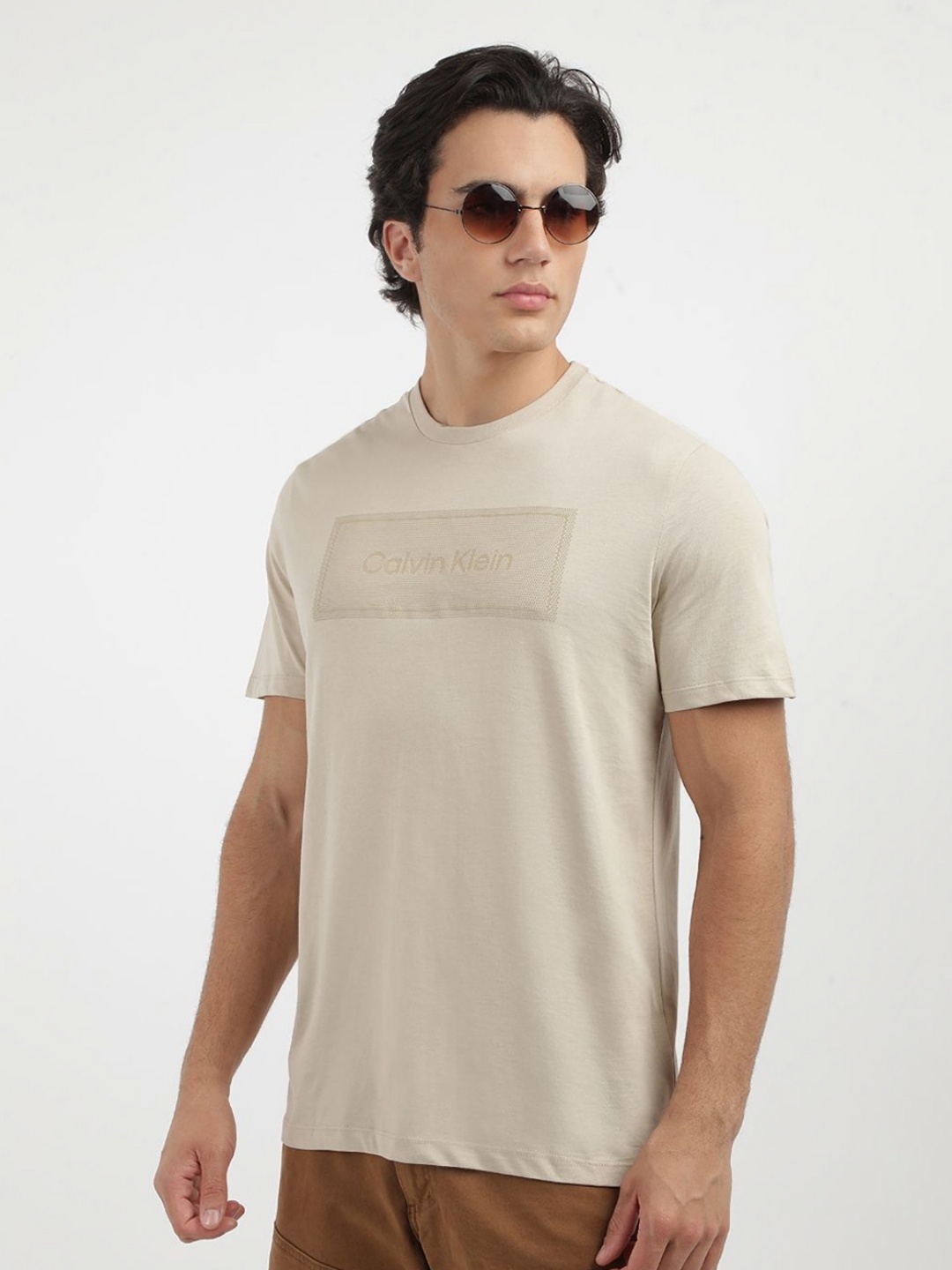 

Calvin Klein Jeans Men Typography Printed Round Neck Cotton T-shirt, Beige