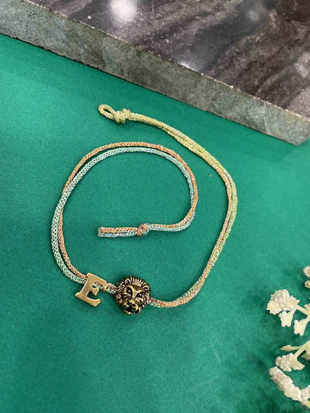 

Digital Dress Room E Letter Lion Charm Thread Rakhi, Gold