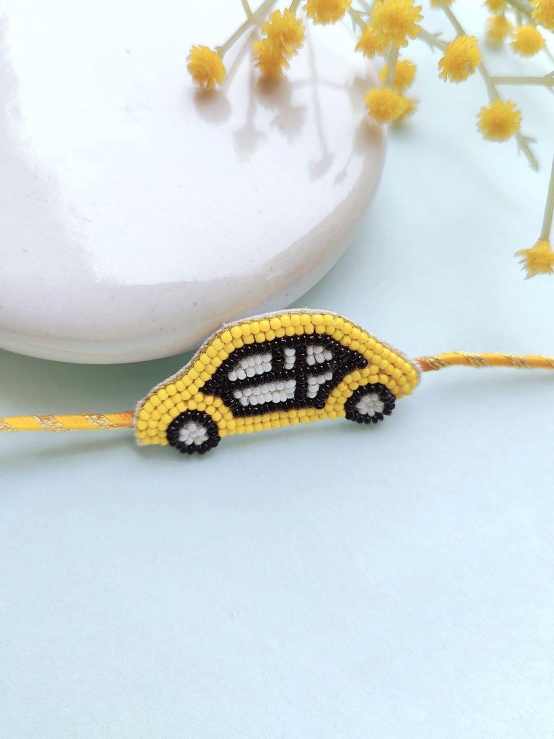 

Crunchy Fashion Kids Beaded Car Thread Rakhi, Yellow