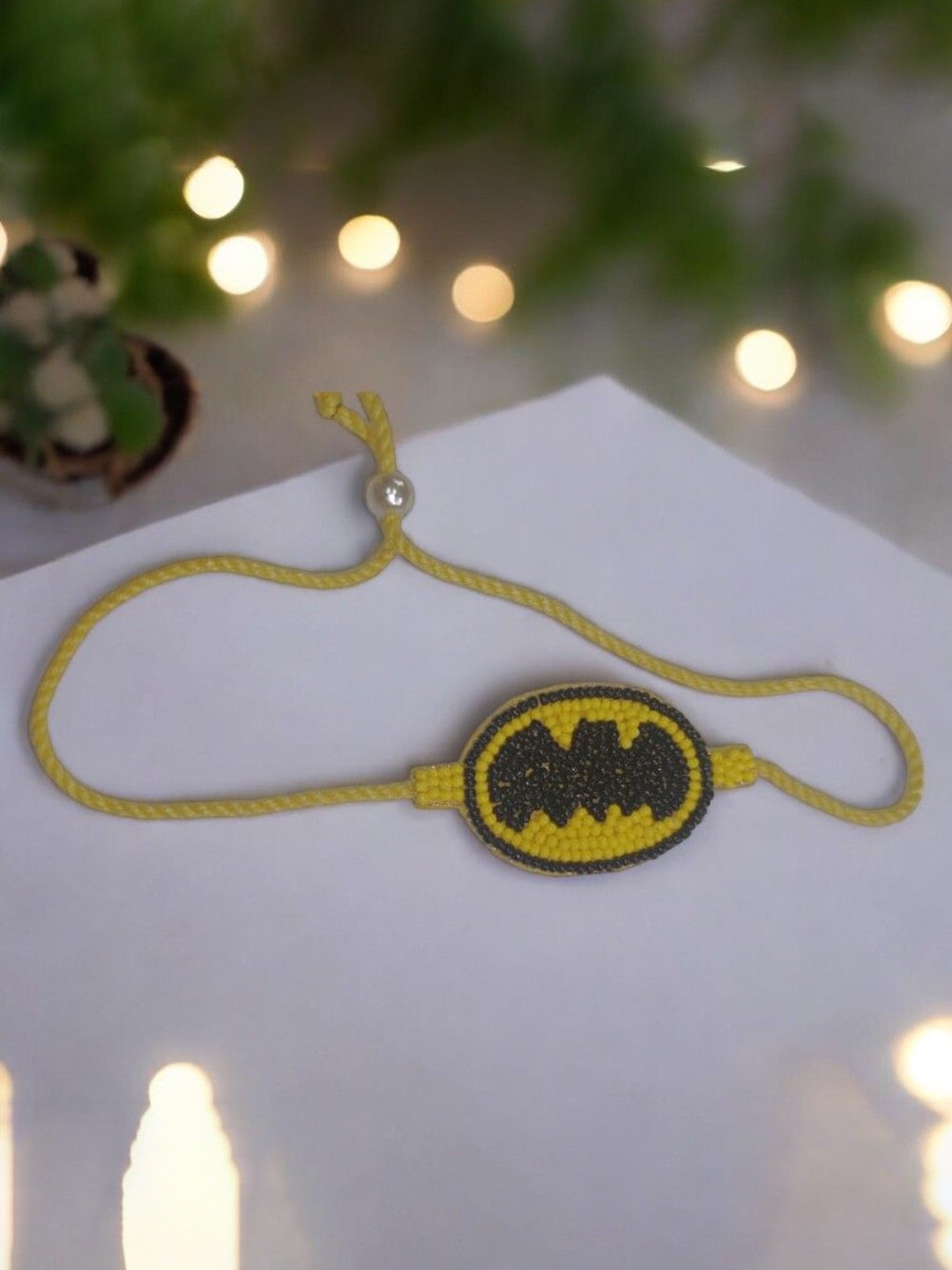 

PRIAANSHA CREATIONS Batman Beaded Thread Rakhi With Roli Chawal, Yellow