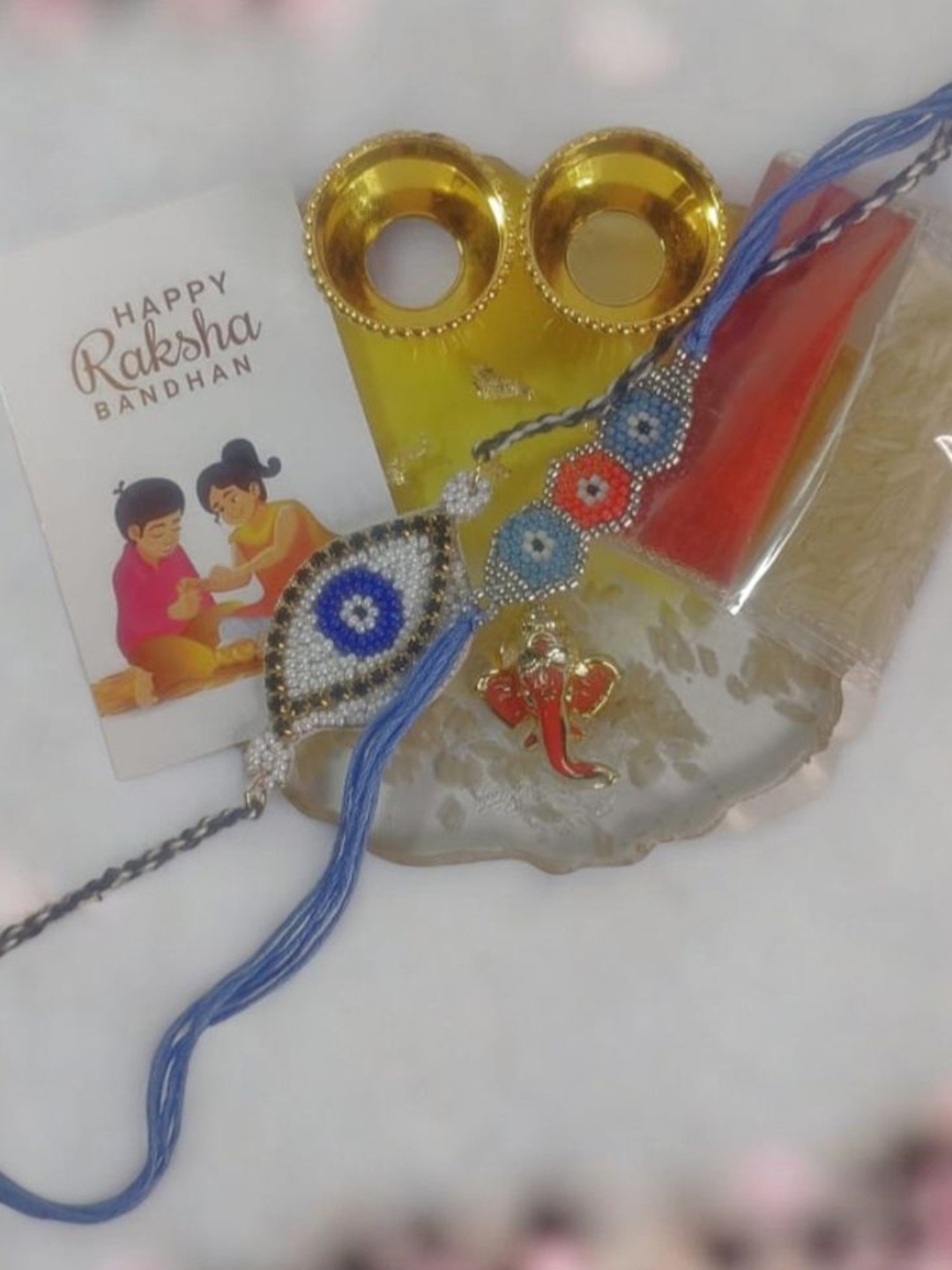 

PRIAANSHA CREATIONS Set Of 3 Beaded Rakhi With Thali Roli Chawal & Greeting Card Gift Set, Blue