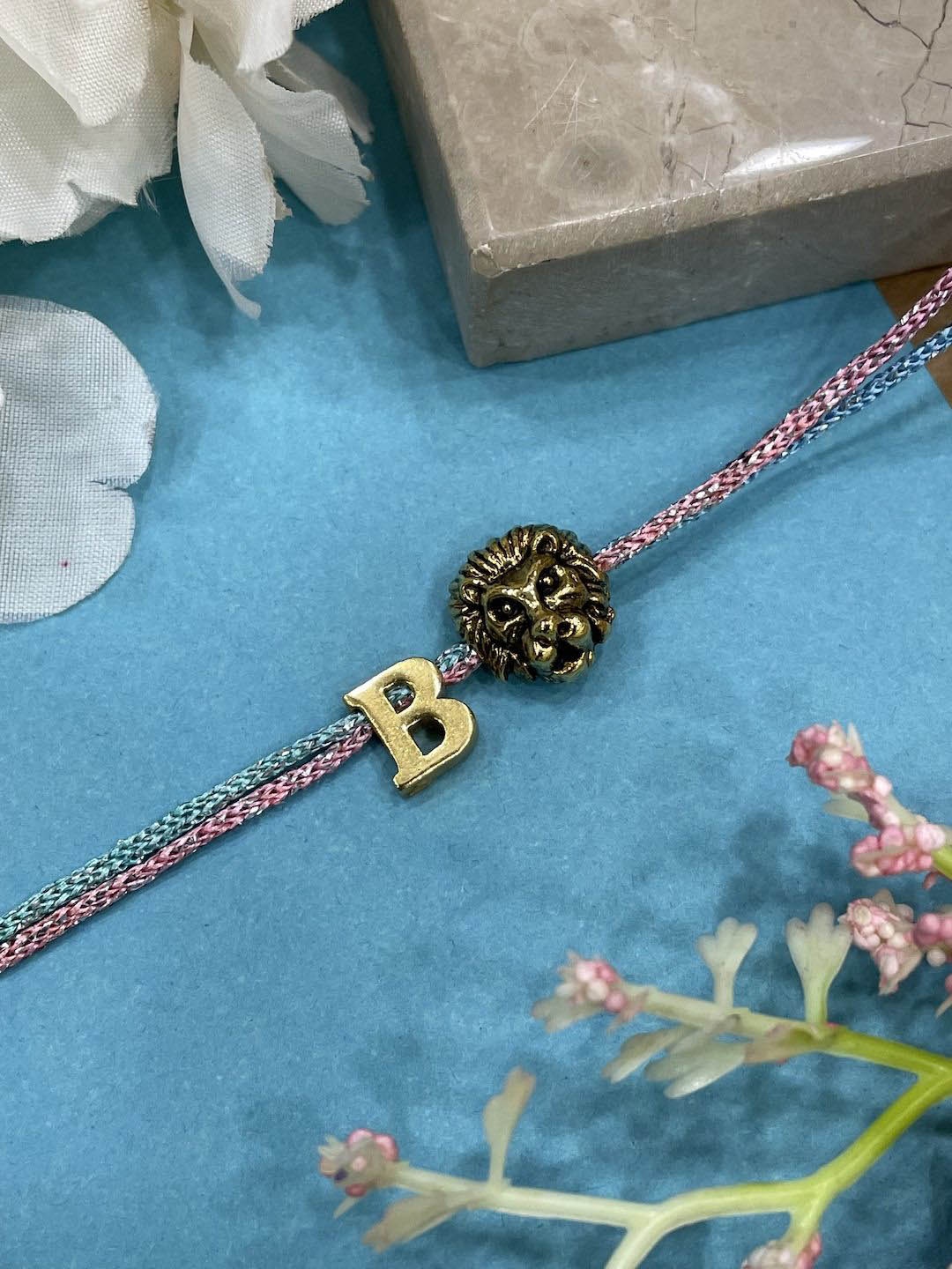 

Digital Dress Room B Initial Lion Charm Thread Rakhi, Gold