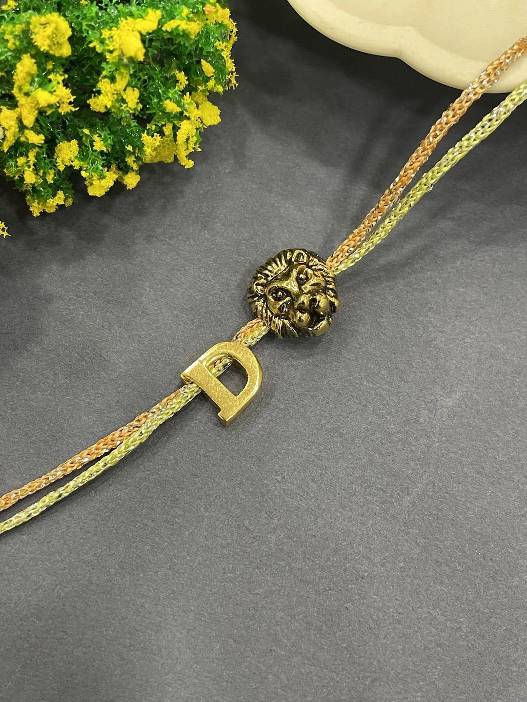 

Digital Dress Room D Initial Lion Charm Thread Rakhi, Gold