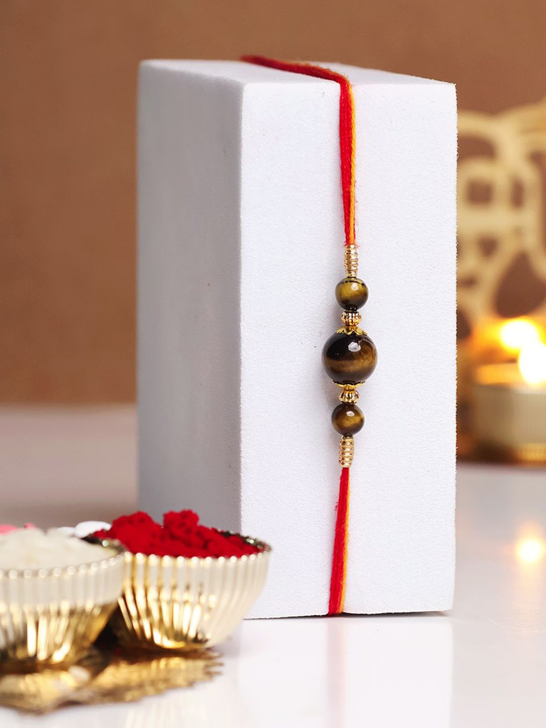 

Shubhanjali Tiger Eye Beaded Thread Rakhi With Roli Chawal & Greeting Card, Brown