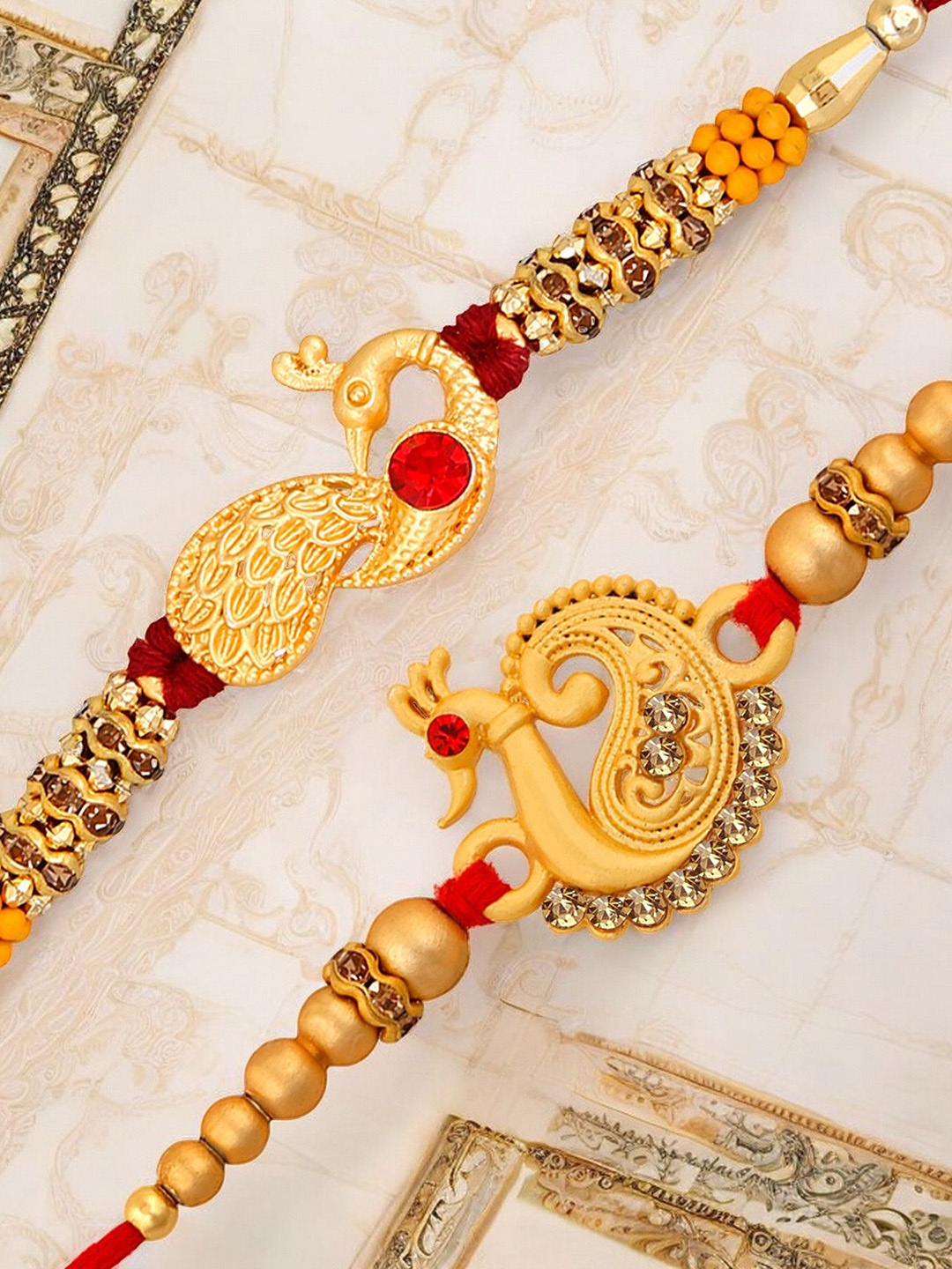 

Okos Set Of 2 Luxurious Matte Peacock Rakhis, Gold