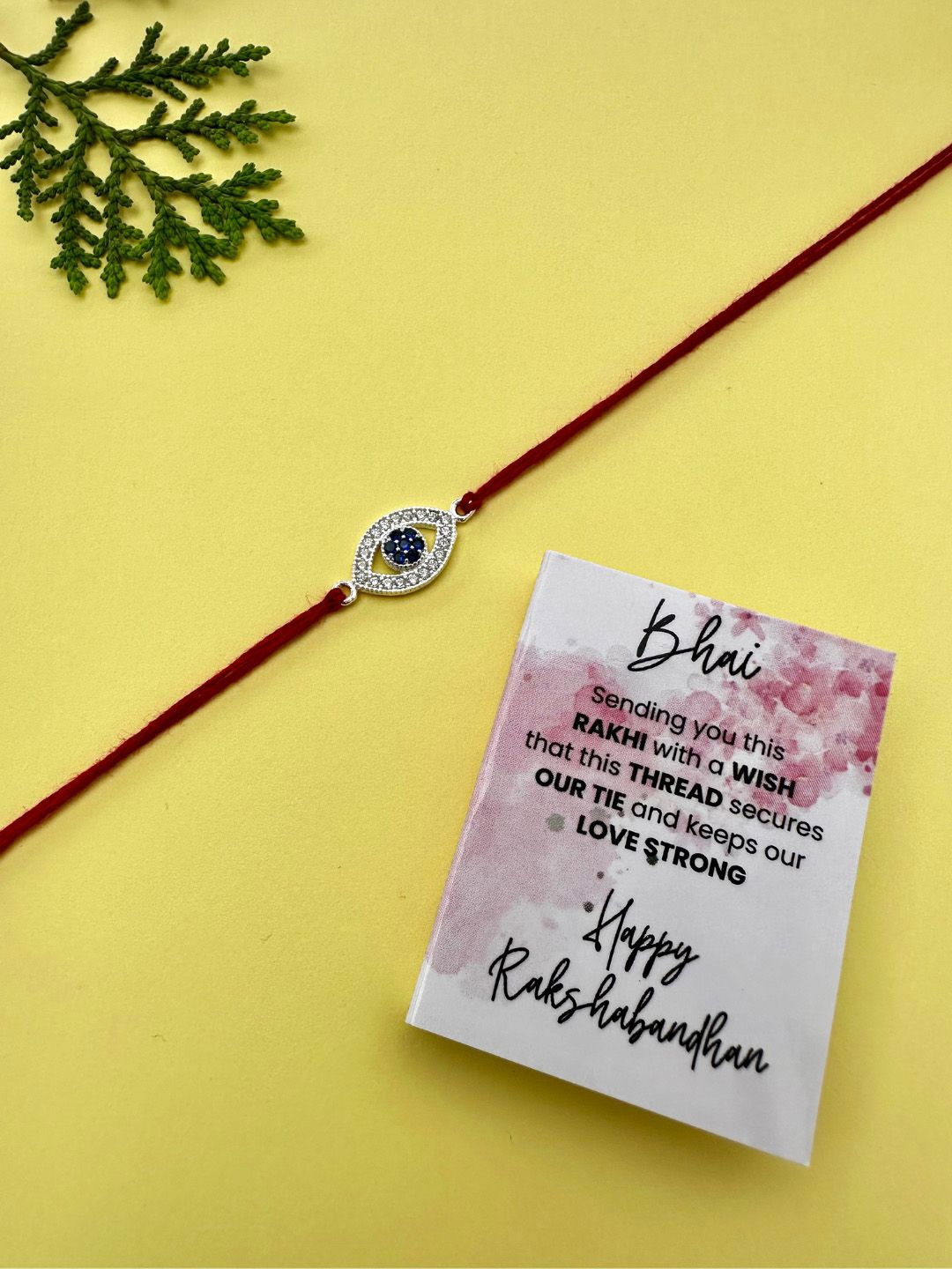 

JUPRA 925 Sterling Silver Evil Eye Nazar Thread Rakhi With Roli Chawal & Greeting Card