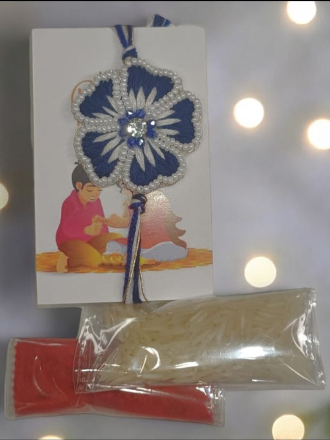 

PRIAANSHA CREATIONS Floral Detailed Embellished Rakhi With Roli & Chawal, Blue