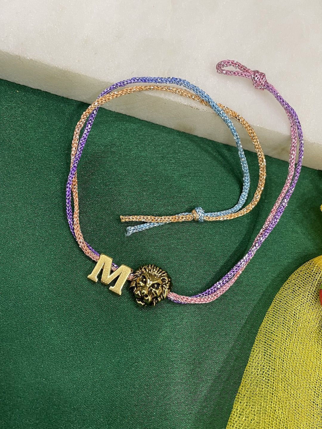 

Digital Dress Room M Letter Lion Charm Thread Rakhi, Gold