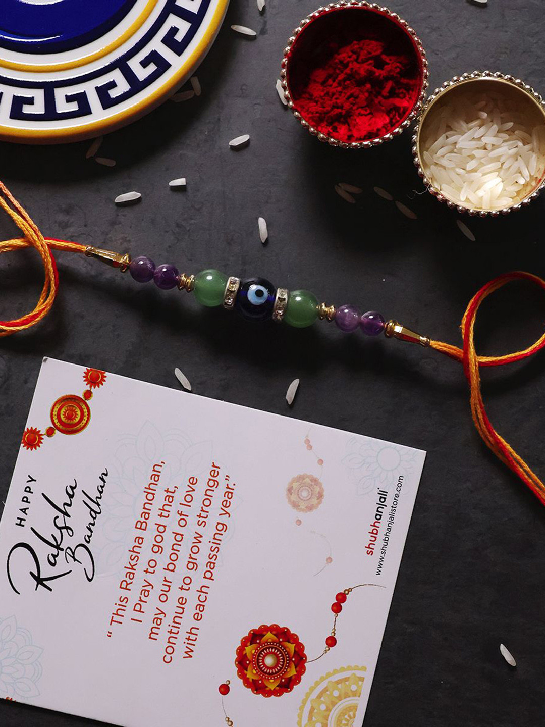 

Shubhanjali Evil Eye Health & Luck Thread Rakhi With Roli Chawal & Greeting Card, Blue