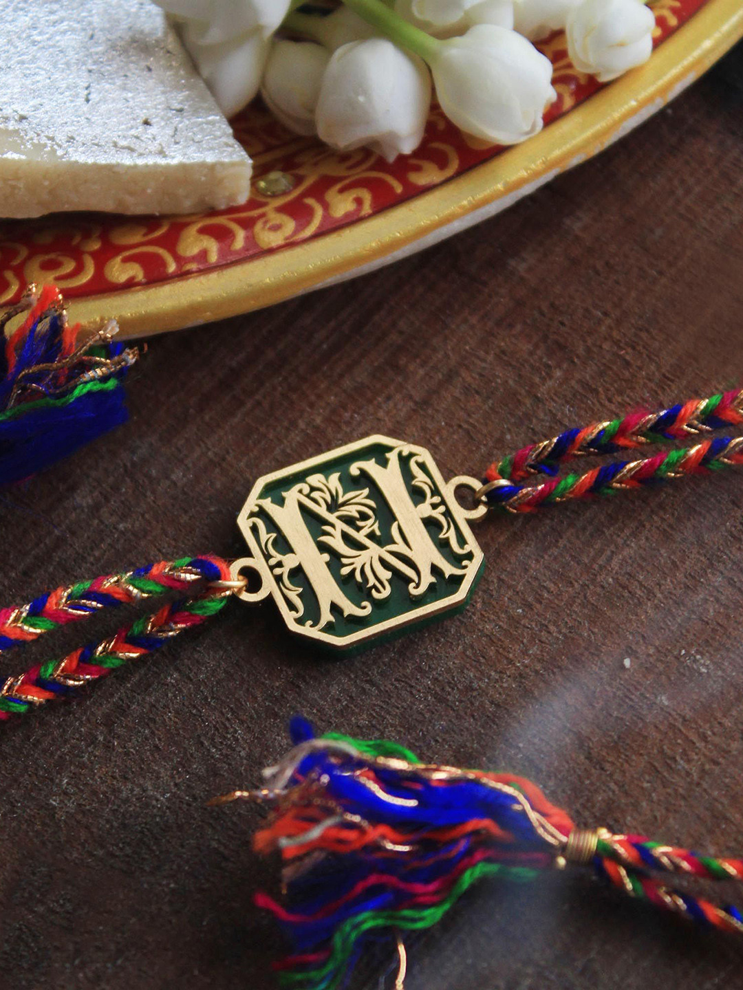 

BeAbhika Blooming K Initial Charm Thread Rakhi With Roli Chawal Capsules, Gold