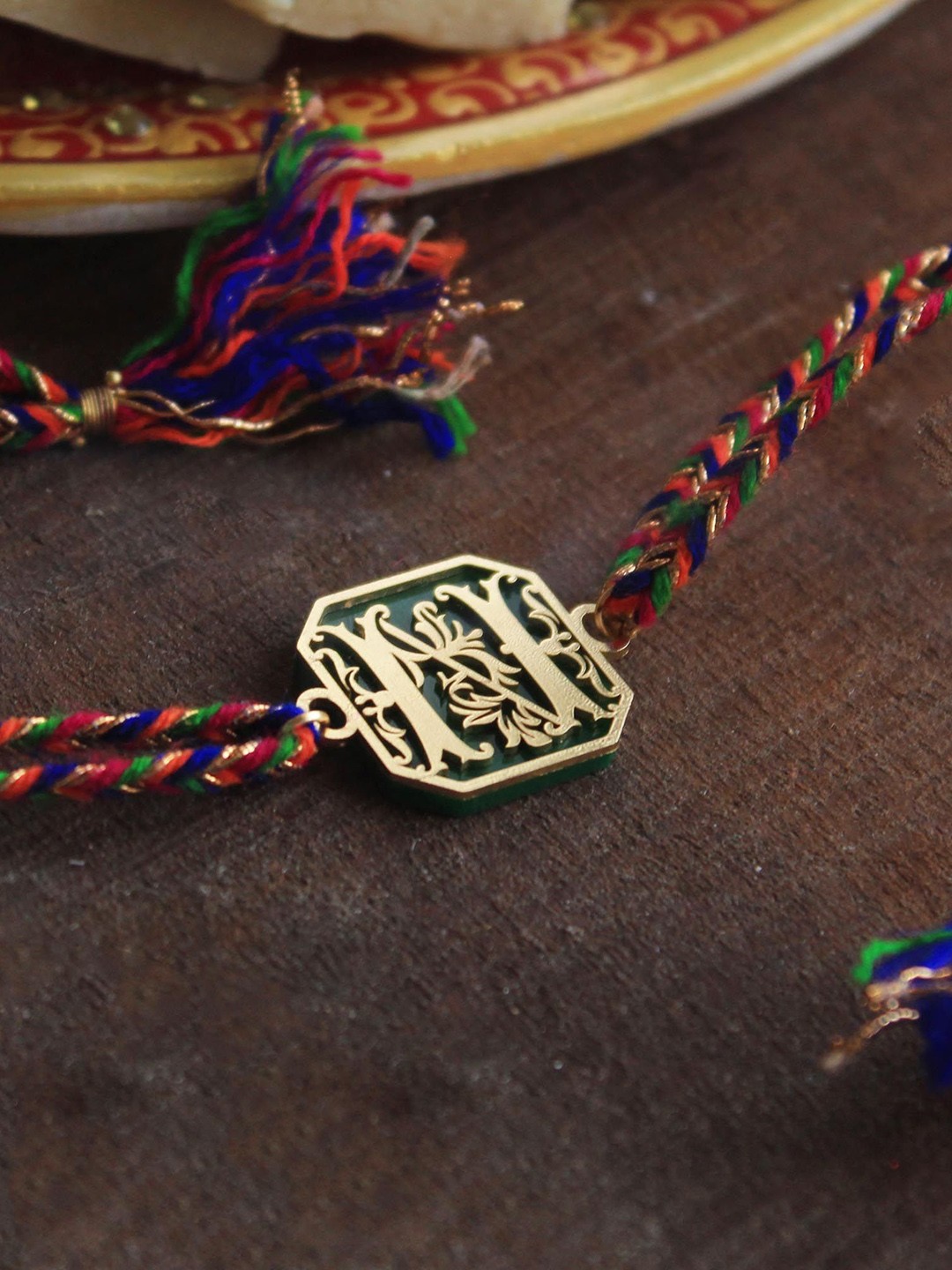 

BeAbhika Blooming E Initial Charm Thread Rakhi With Roli Chawal Capsules, Green