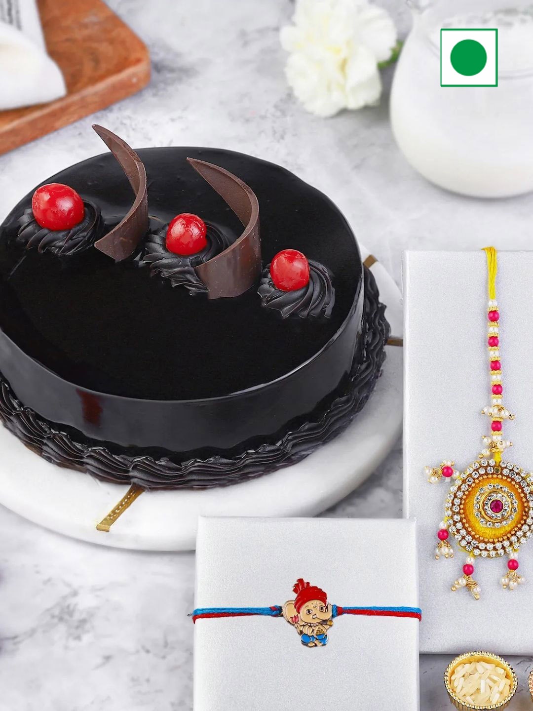 

fnp Set Of 2 Lumba Rakhi & Truffle Cake With Roli Chawal Gift Set, Yellow
