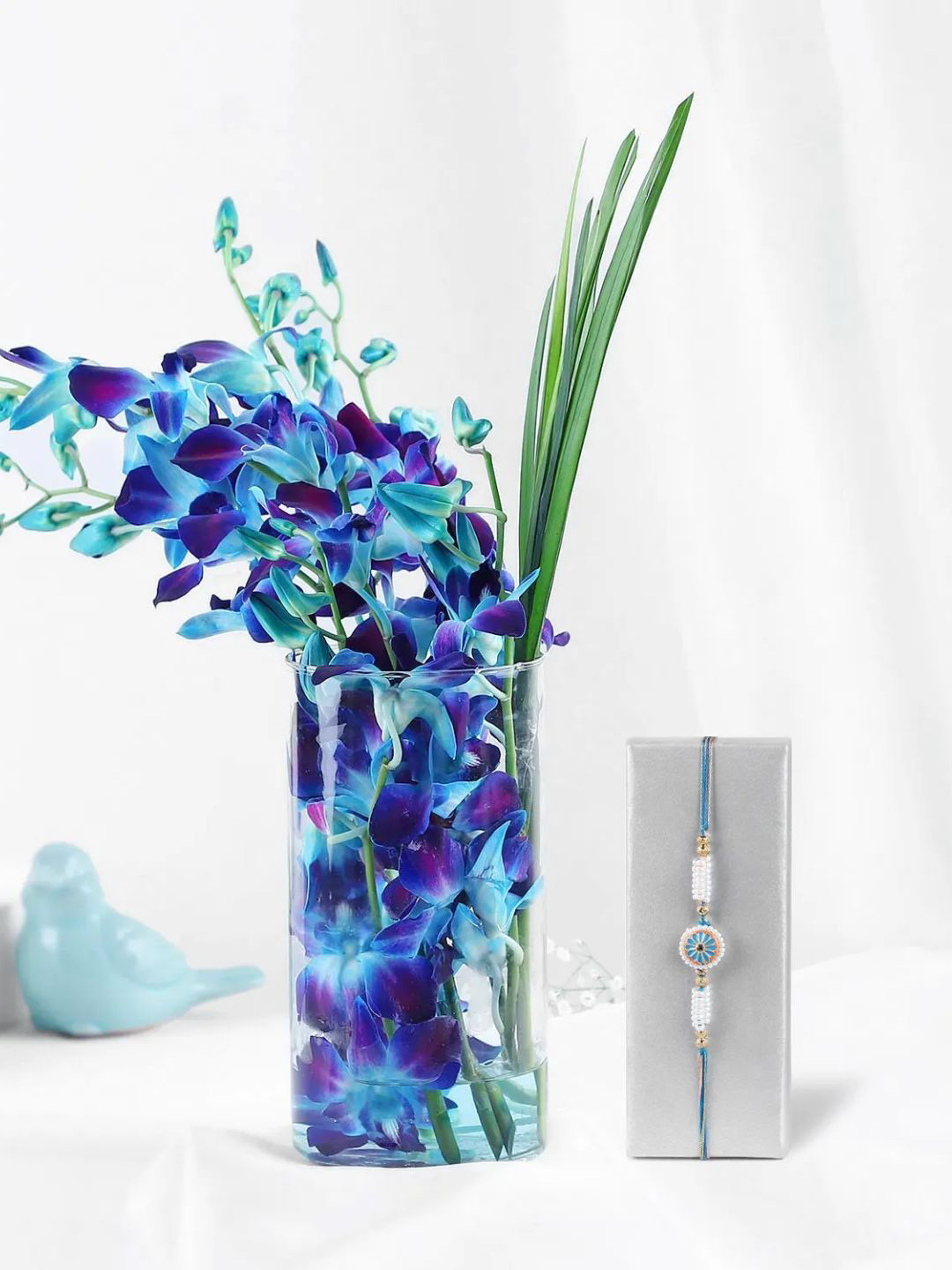 

fnp Purple 6Pc Enchanting Orchids With Glass Vase Rakhi
