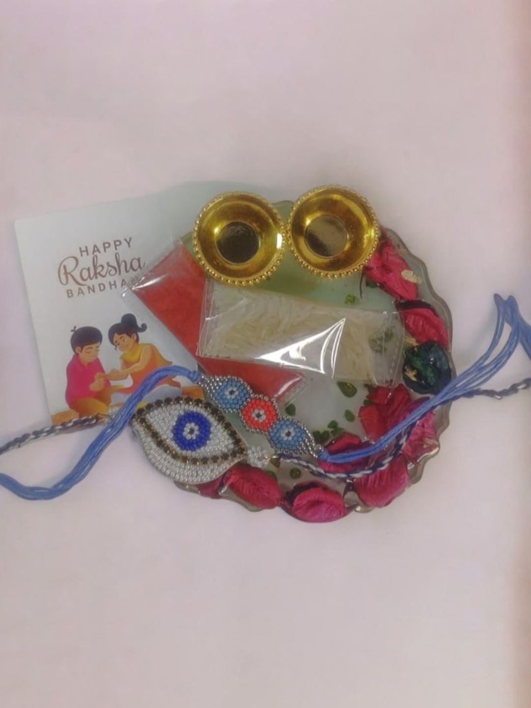 

PRIAANSHA CREATIONS Set Of 3 Beaded Rakhi With Thali Roli Chawal & Greeting Card Gift Set, Blue