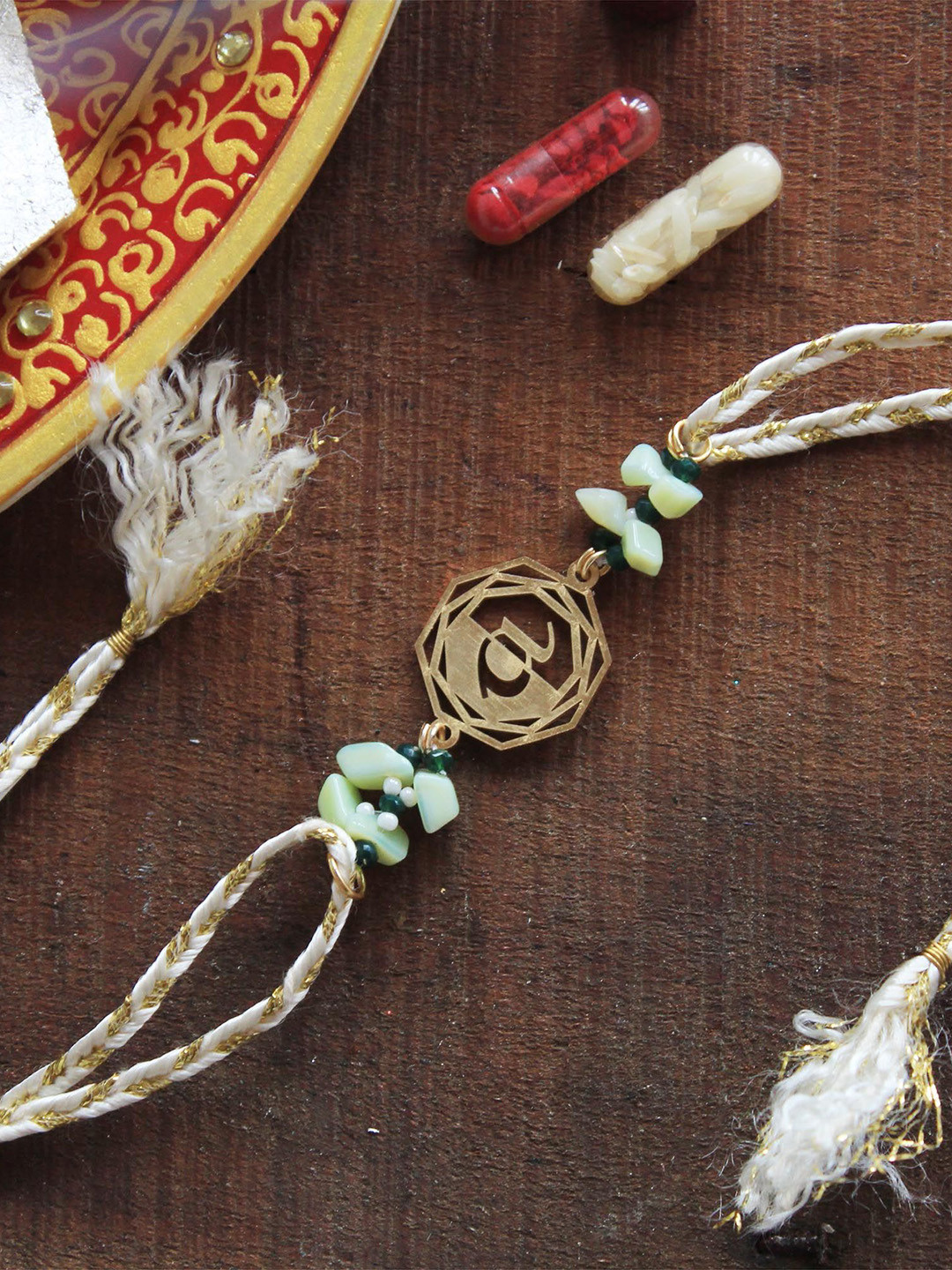 

BeAbhika Blooming A Initial Beaded Thread Rakhi With Roli Chawal Capsules, Gold