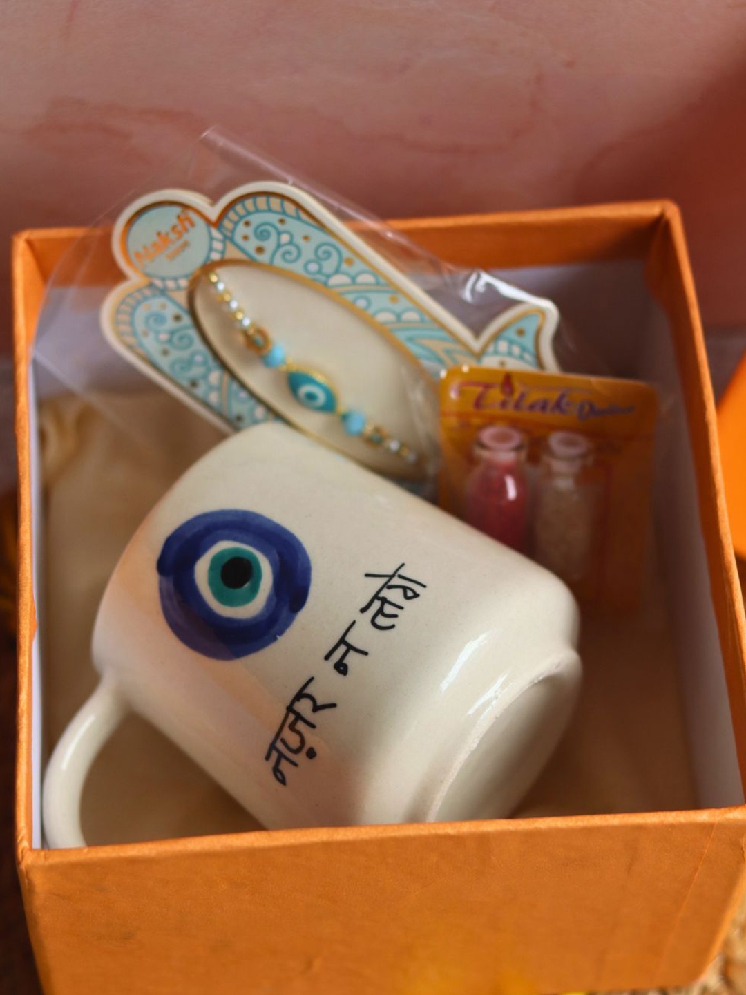 

WEAVING HOMES Set Of 2 Rakhi With Nazar Bhai Mug, White